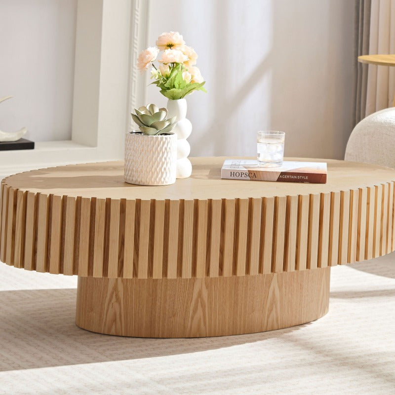 Contemporary Handcrafted Drum-Shaped Coffee Table, Measuring 43.7 Inches in Length, Designed in an Oval Shape for The Living Room. This Compact Coffee Table Boasts a Robust Pedestal Base And Is Made from Natural Ash, Perfect for Modern Home Decor.